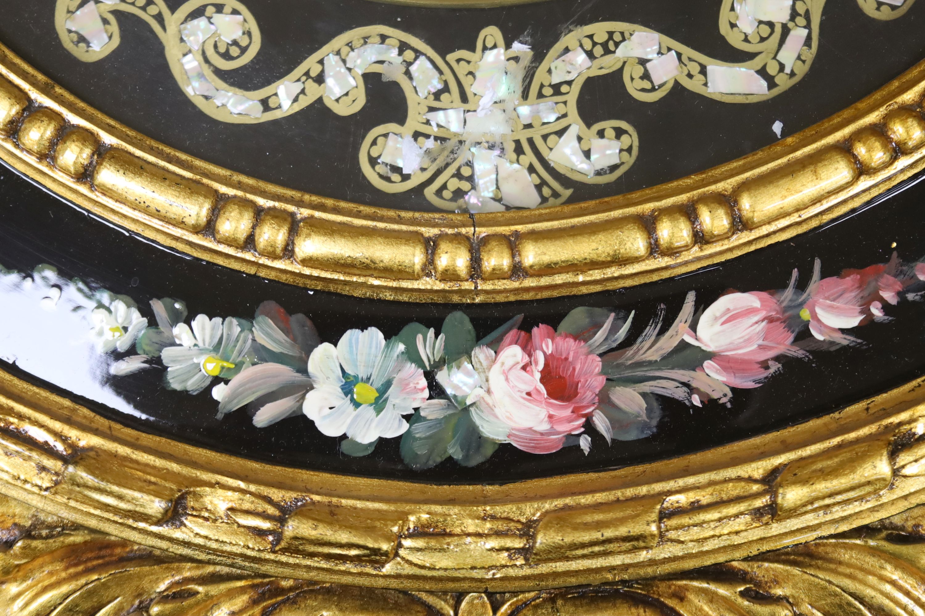 A floral painted clock, length 63cm, quartz movement